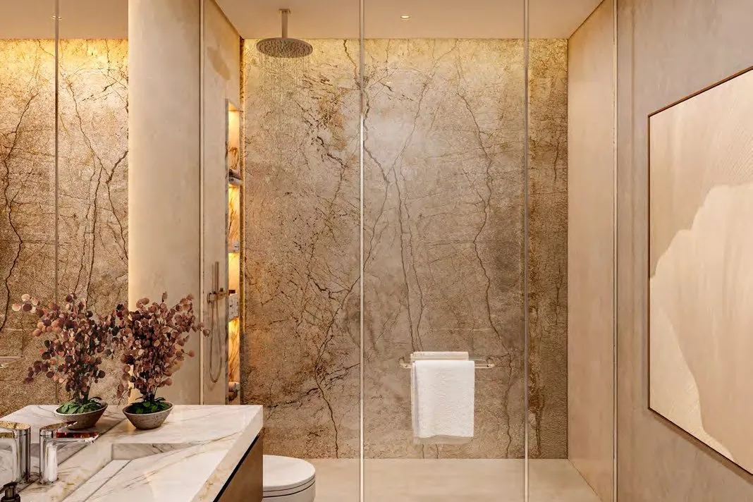 Bathroom with veined stone walls, walk-in shower and marble vanity