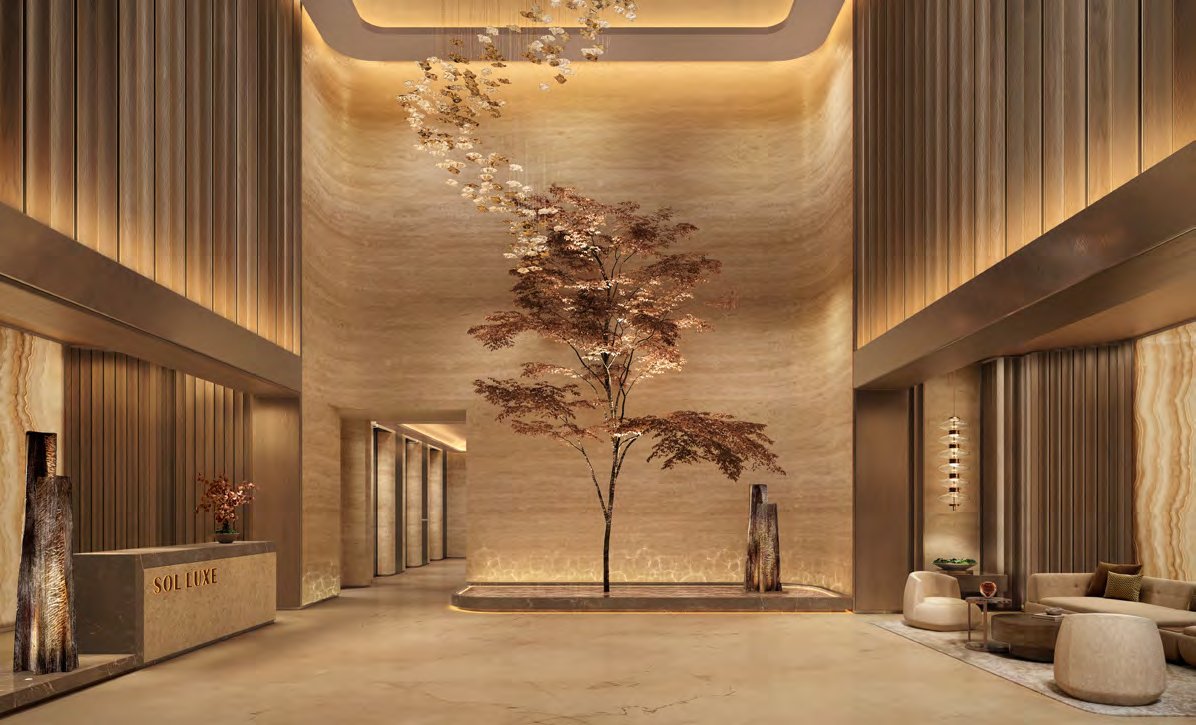 Double-height lobby in travertine and bronze with a sculptural tree